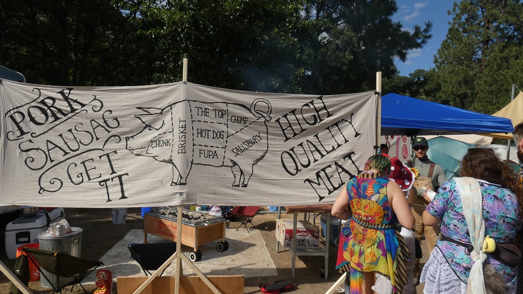 Sign detailing multiple pork cuts as people wait to be served.