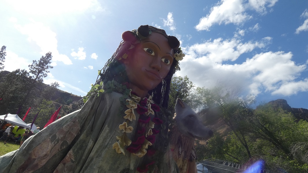 Giant mannequins in the form of Mother Earth and Wolfman walking about the SOAK Grounds.