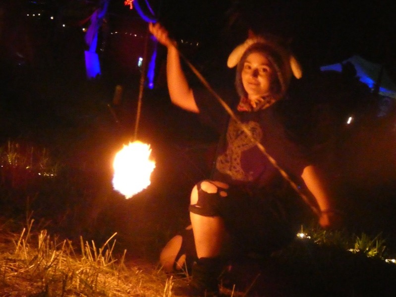 casual camera soak body 

Woman poses with rope dart in the fire circle.